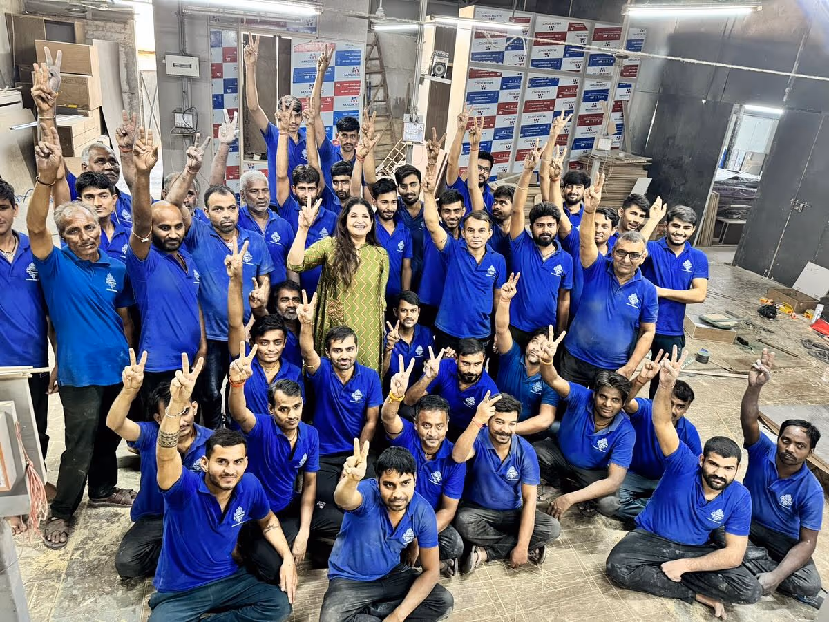 The large in-house team of craftsmen and staff gathered at a furniture manufacturer's factory.