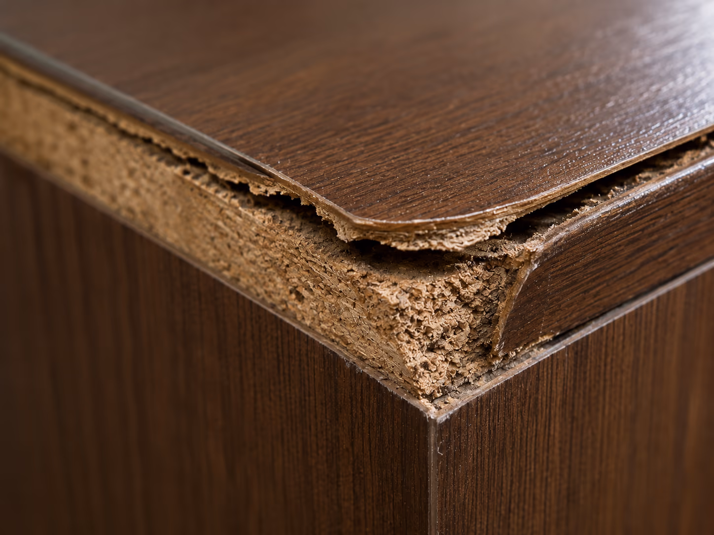 Cracked and lifted veneer edge on imported furniture after an Indian humid season