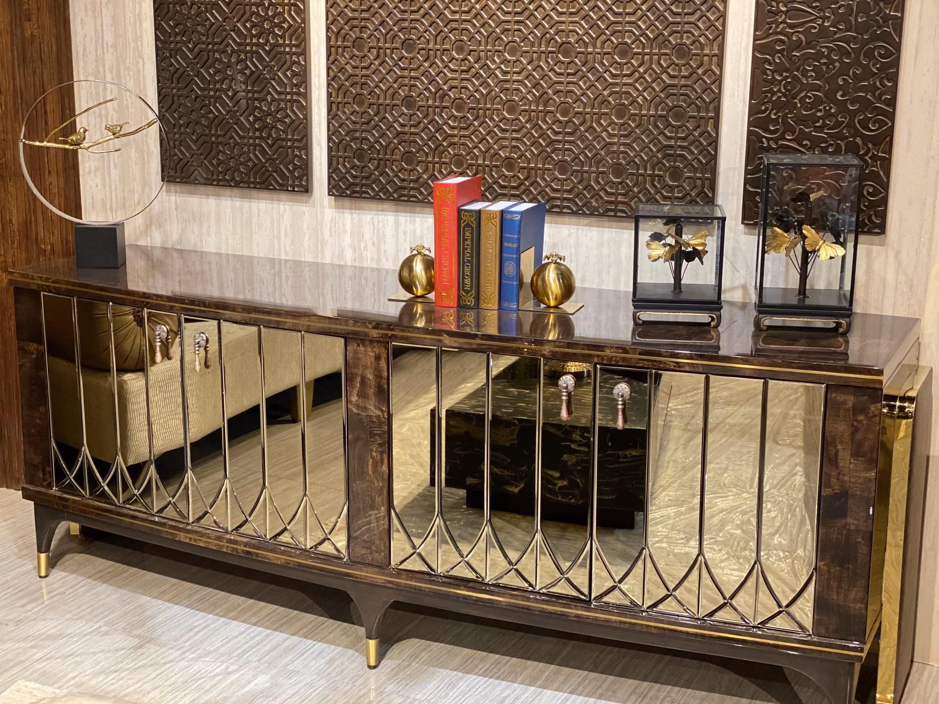 Sideboard with antiqued mirror doors in a diamond bevel pattern, dark burl-wood and brass frame, silver drop handles and tapered legs with brass caps.