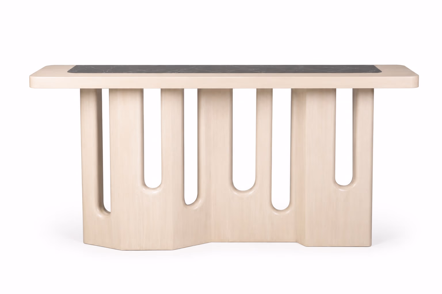 Long console table in bleached oak with a black marble inset top and a sculptural base carved into rounded vertical slots, front view.