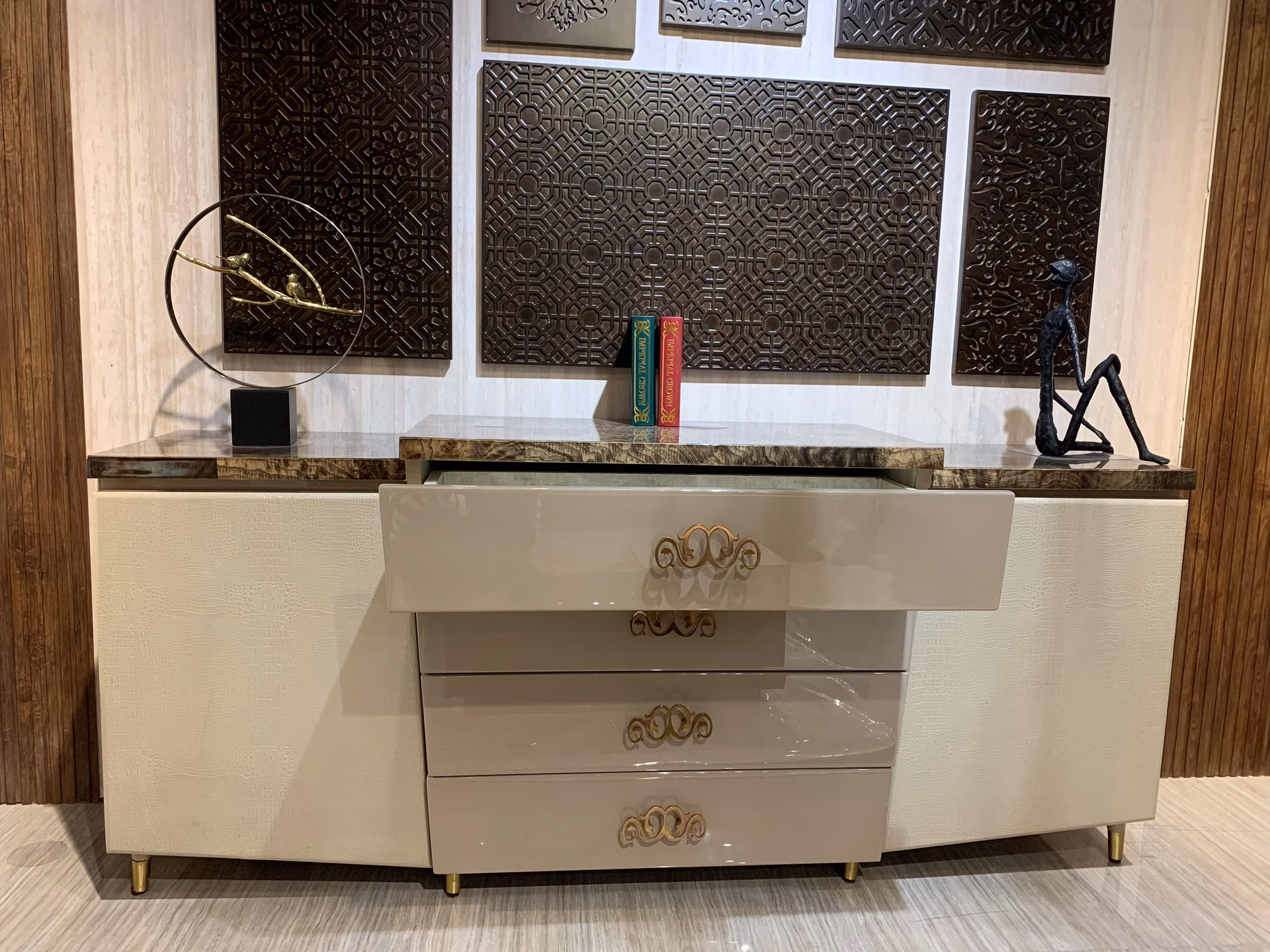 The cream croc-textured sideboard with its top gloss drawer pulled open to show the lined interior beneath the marble top.