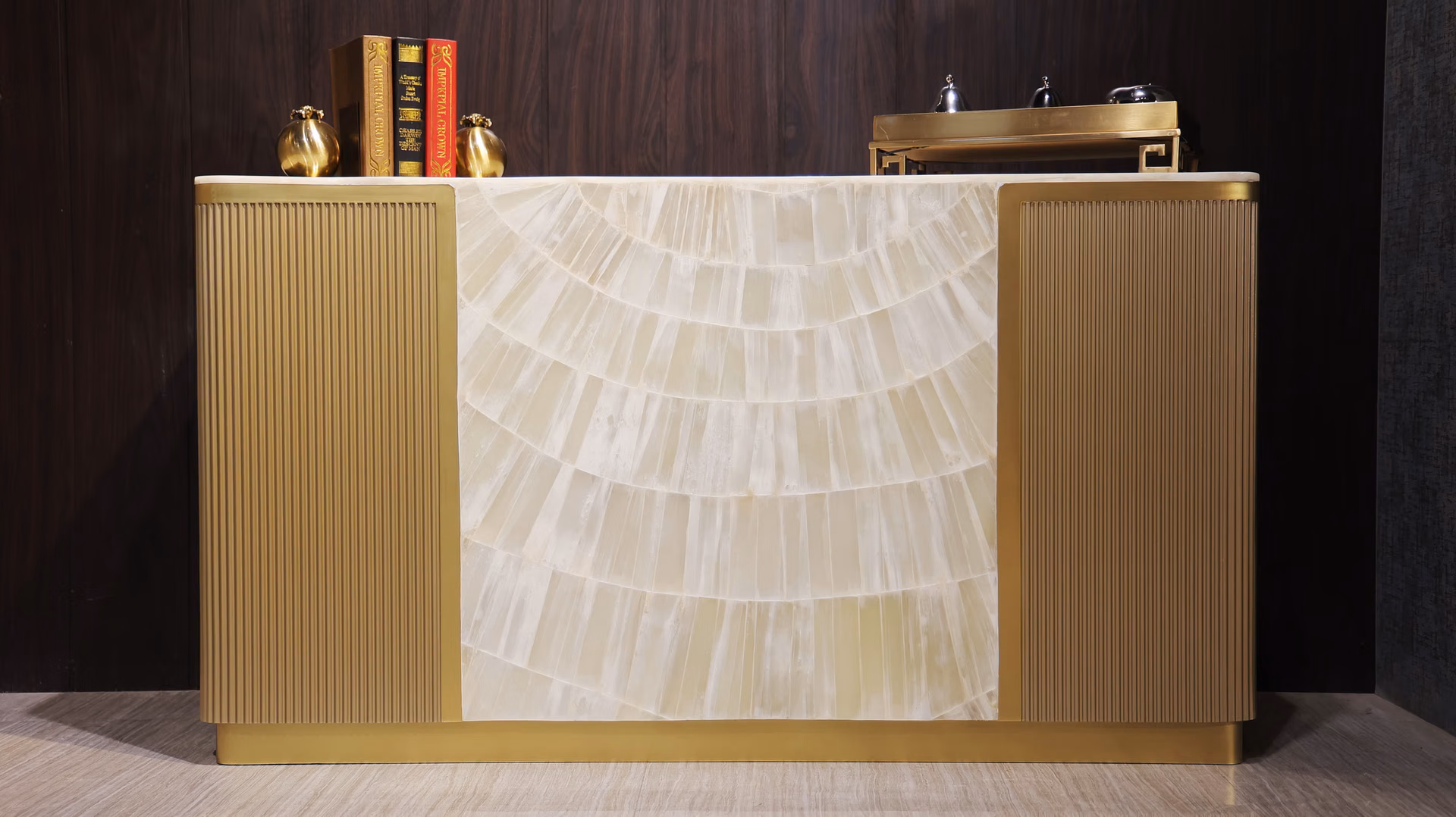 Wide buffet with a sunburst onyx-stone centre panel flanked by fluted brass-finished side doors.