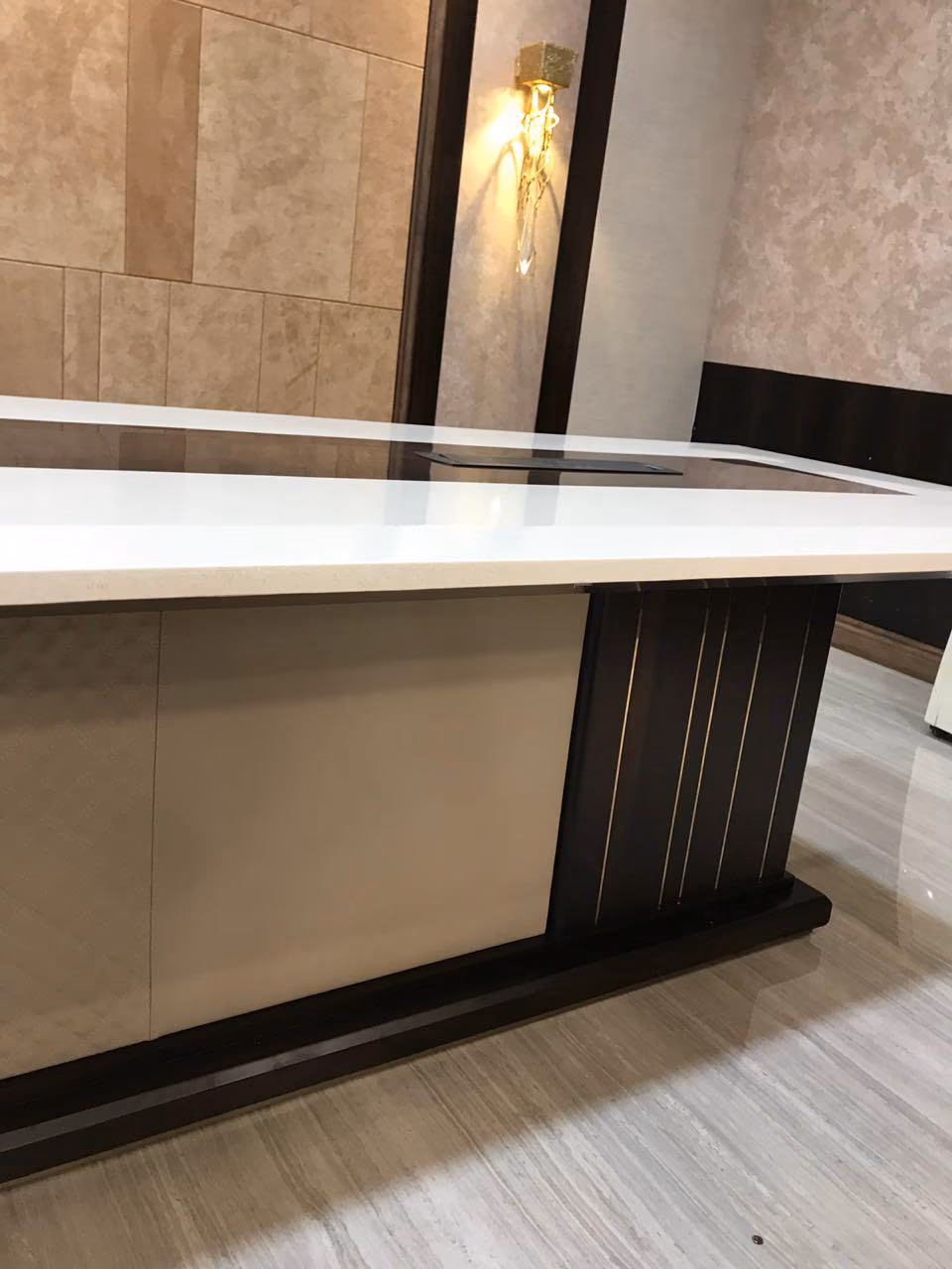 A fluted panel-end base on a custom boardroom table, set in from the ends to clear the seats.