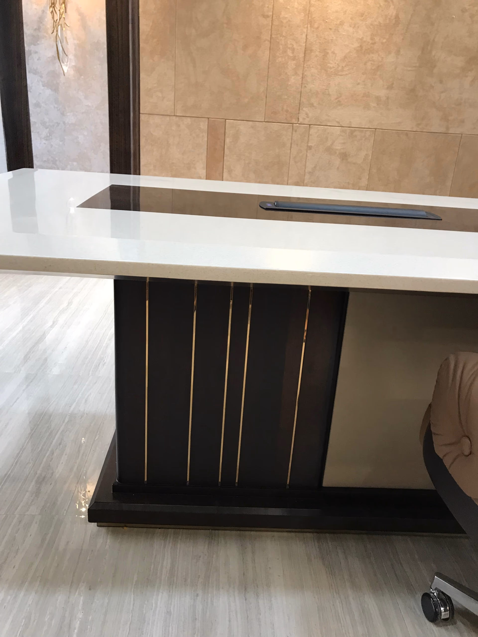 A custom boardroom table with a white quartz top, sized to the room and its chair clearances.