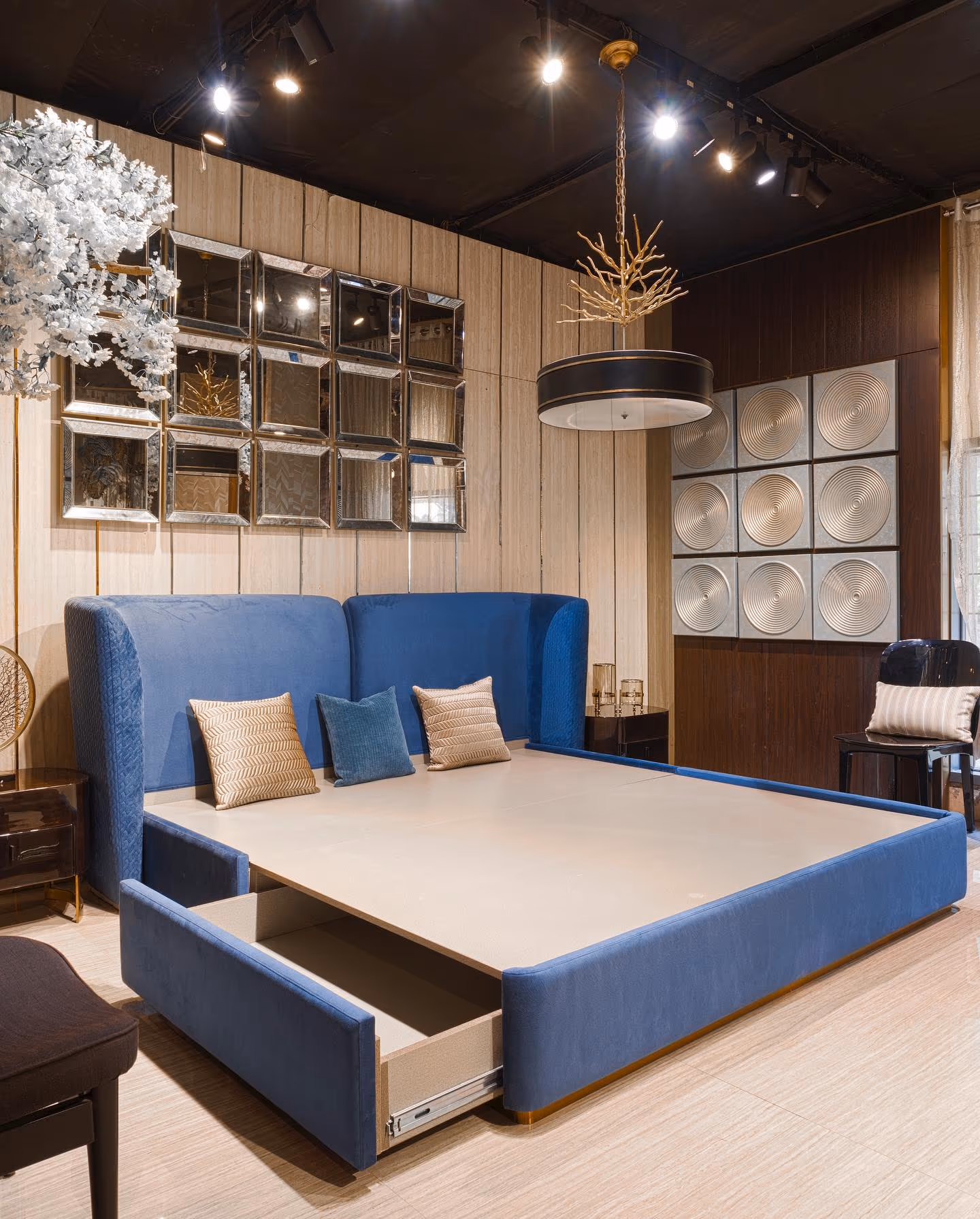 A luxury bedroom with a fitted upholstered headboard wall and custom side tables.