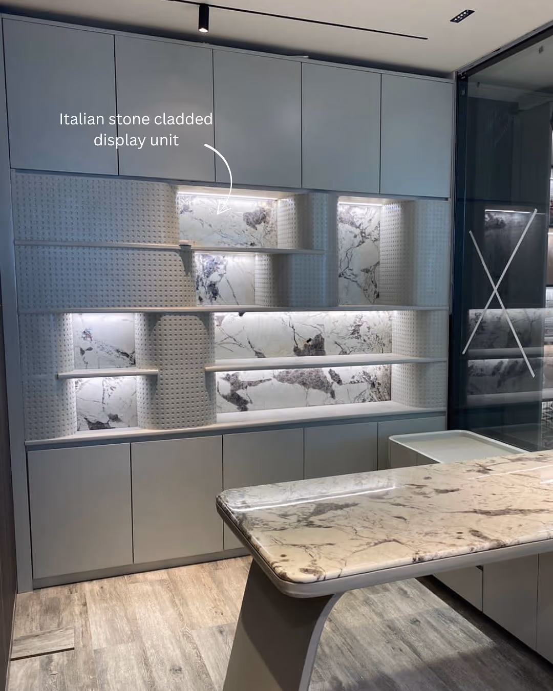 A luxury kitchen display unit pairing fine finished panels with hard-working stone surfaces.