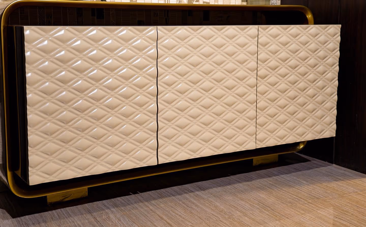 A luxury home bar unit with brass detailing and backlit shelving.