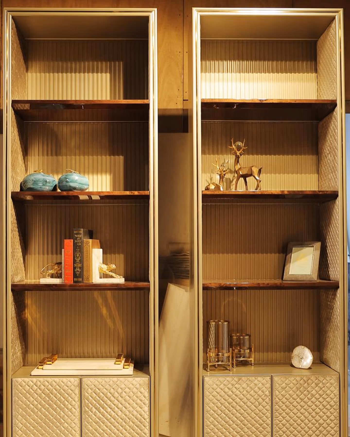 Custom wall shelving fitted neatly around an awkward corner in a luxury room.