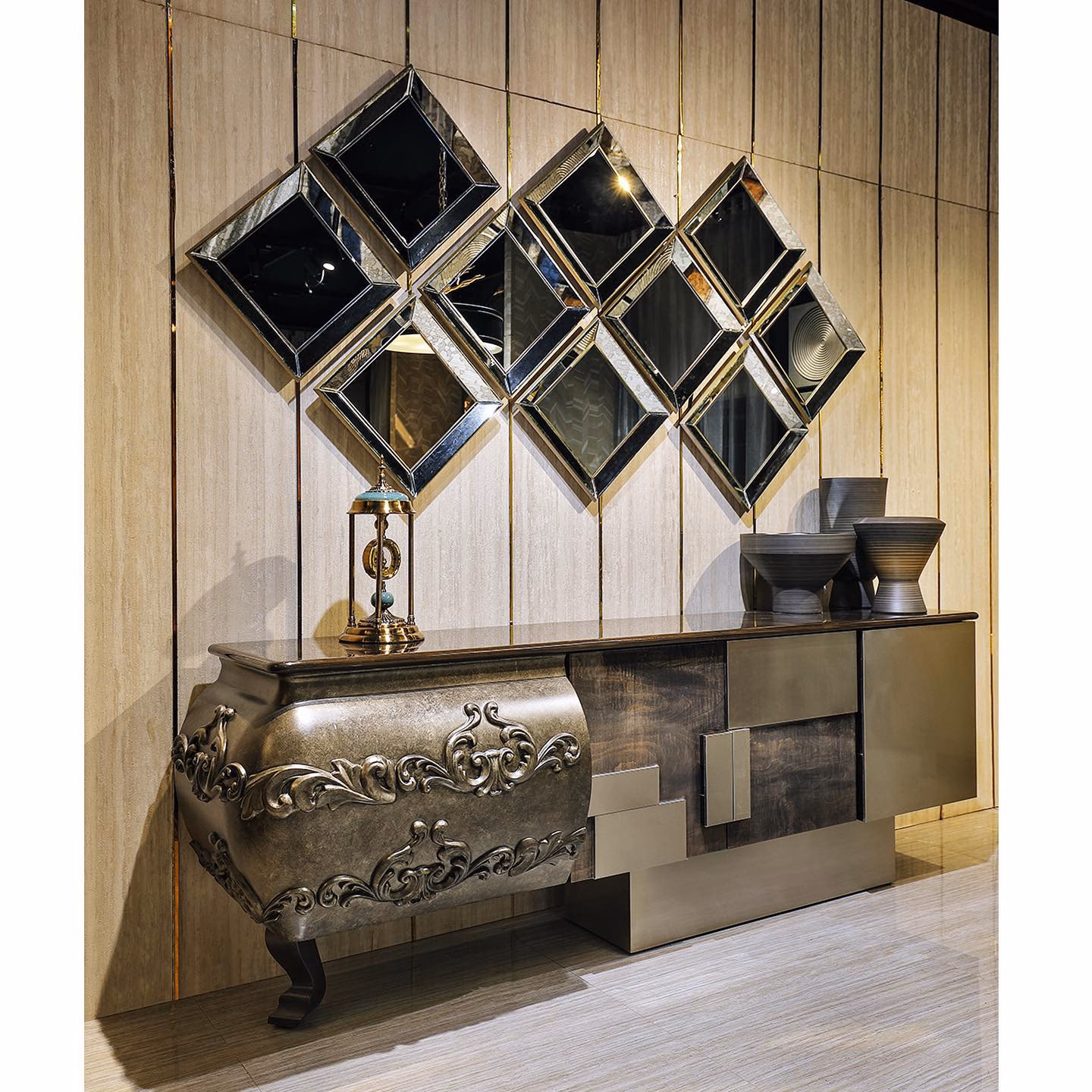Long sideboard with a bowed antique-silver bombé end carved in deep acanthus scrollwork, joined to a stepped modern section in smoked bronze mirror and brushed metal, under a diamond mirror cluster.