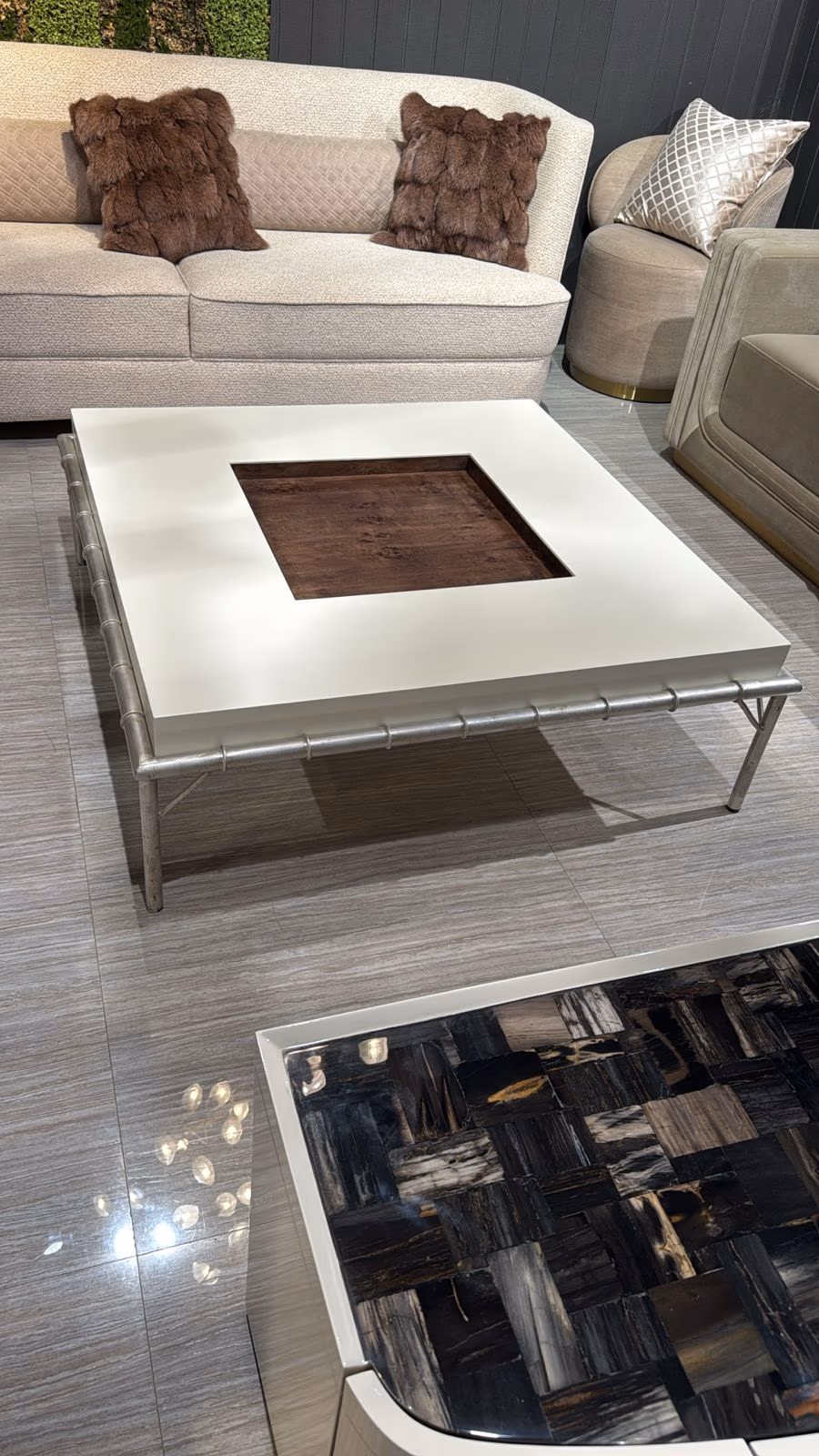 Square ivory lacquer coffee table with a recessed burl wood tray top and slender metal bamboo-style legs.