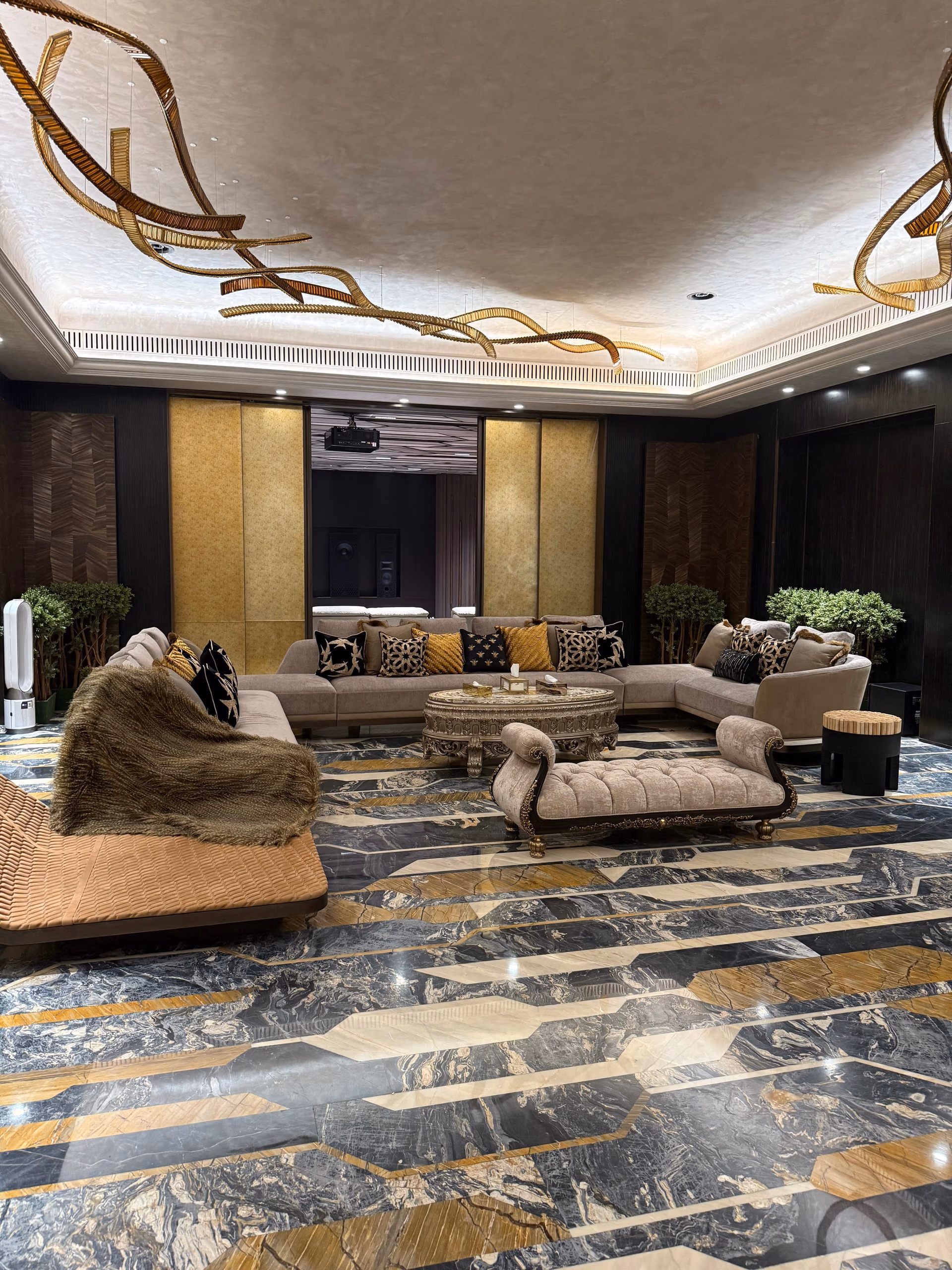 A luxury living room where the sofa, ceiling, lighting, and wall panels all align as one design.