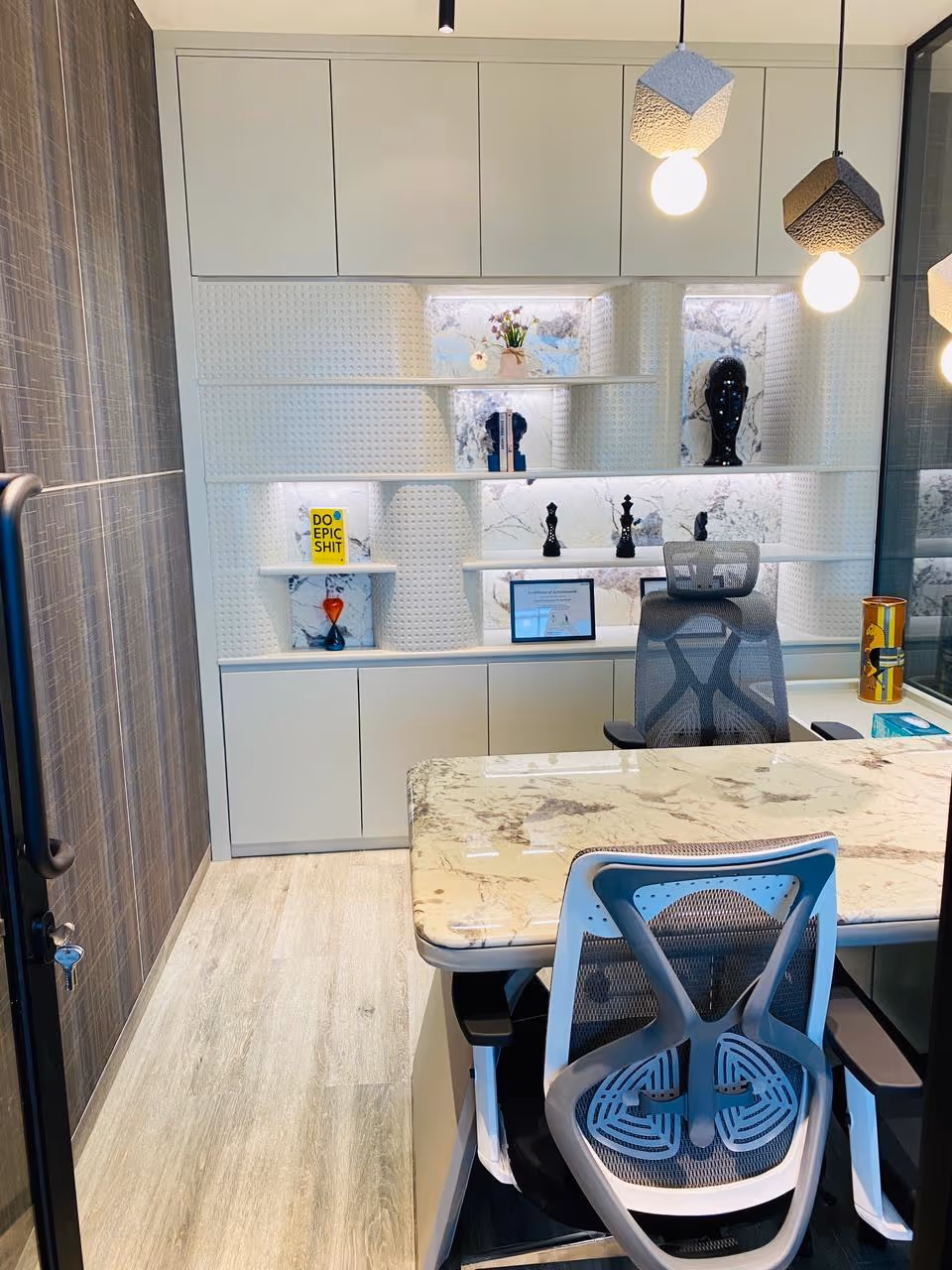 A CEO cabin with a marble-top executive desk and a full-height storage wall, built by a luxury office furniture manufacturer in India.