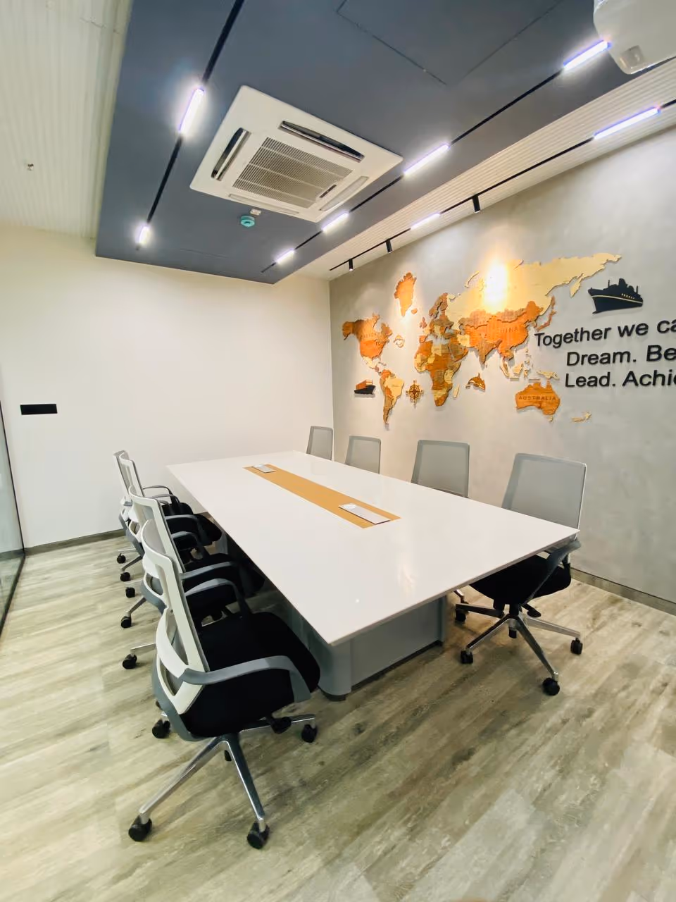 A conference room table with a quartz top and flush power and data boxes set into the surface.