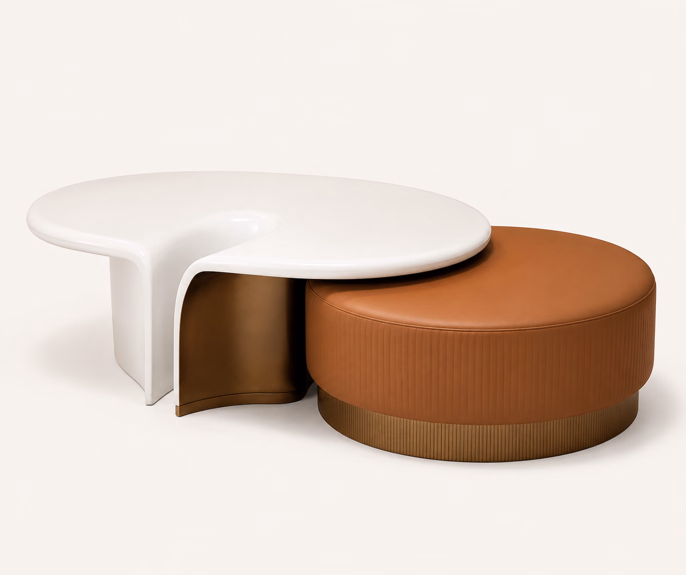 Designatore nesting centre table shown alone on a bone ground, pairing a high-gloss ivory organic-form table on a sculpted leg with a round terracotta ribbed leather ottoman on a fluted antique brass base.