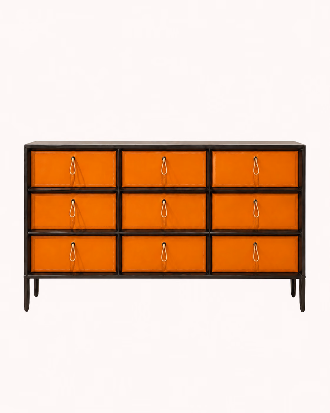 Designatore nine drawer console shown alone, with burnt orange vegan leather drawer fronts in a three by three grid, a black stained wood veneer frame, slim gold pull handles with leather loops and a black powder-coated metal base.