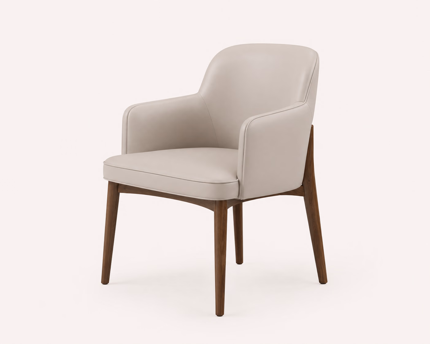 Designatore dining chair upholstered in soft taupe leather with piped seams, a curved low back, wrapped arms and tapered solid walnut legs, shown alone on a bone-white ground.