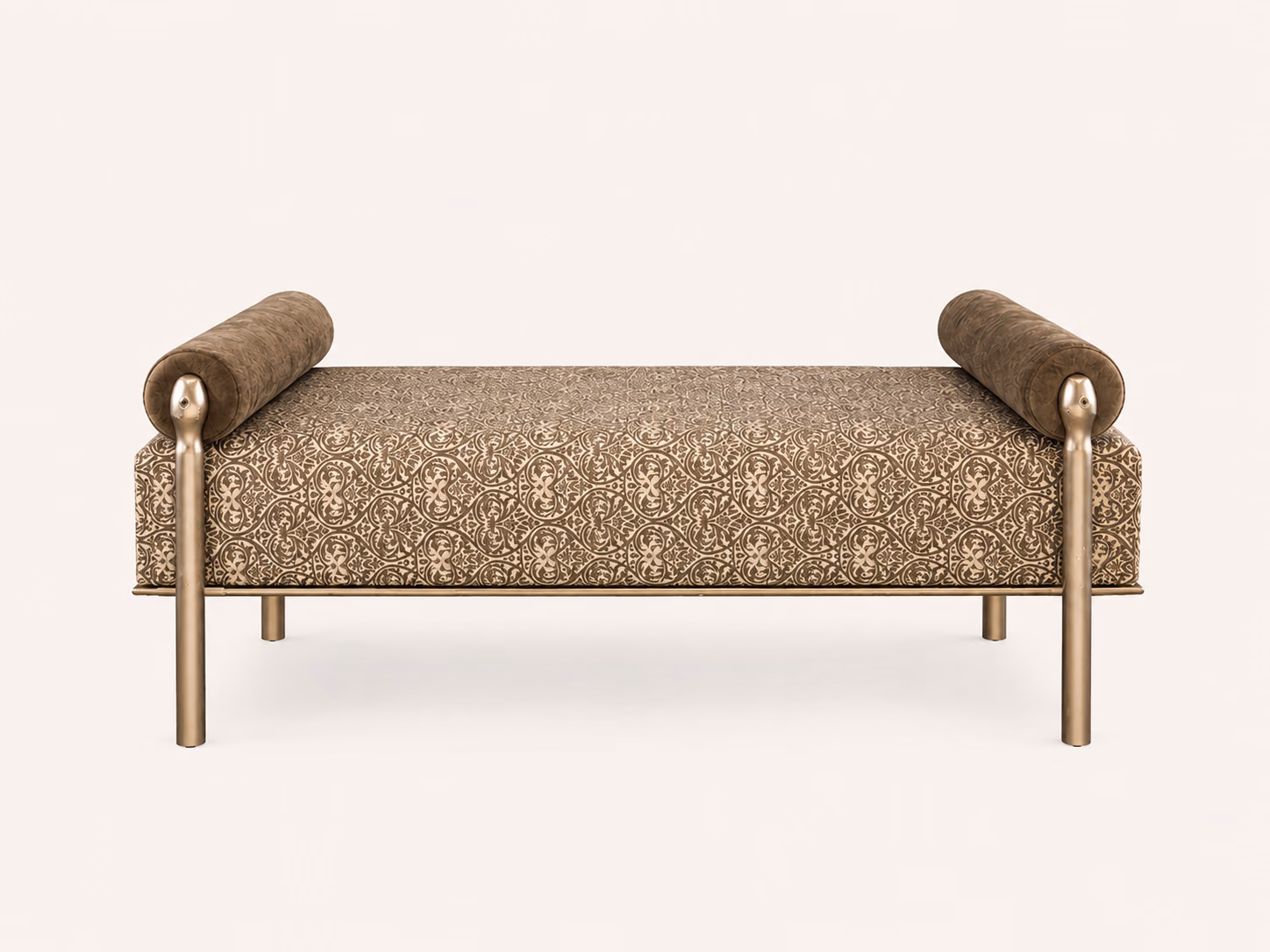 Designatore ottoman bench shown alone on a bone ground, upholstered in a taupe and beige jacquard weave with an ornamental pattern, a plush suede-finish bolster at each end and a slim brushed antique gold metal frame on six legs.